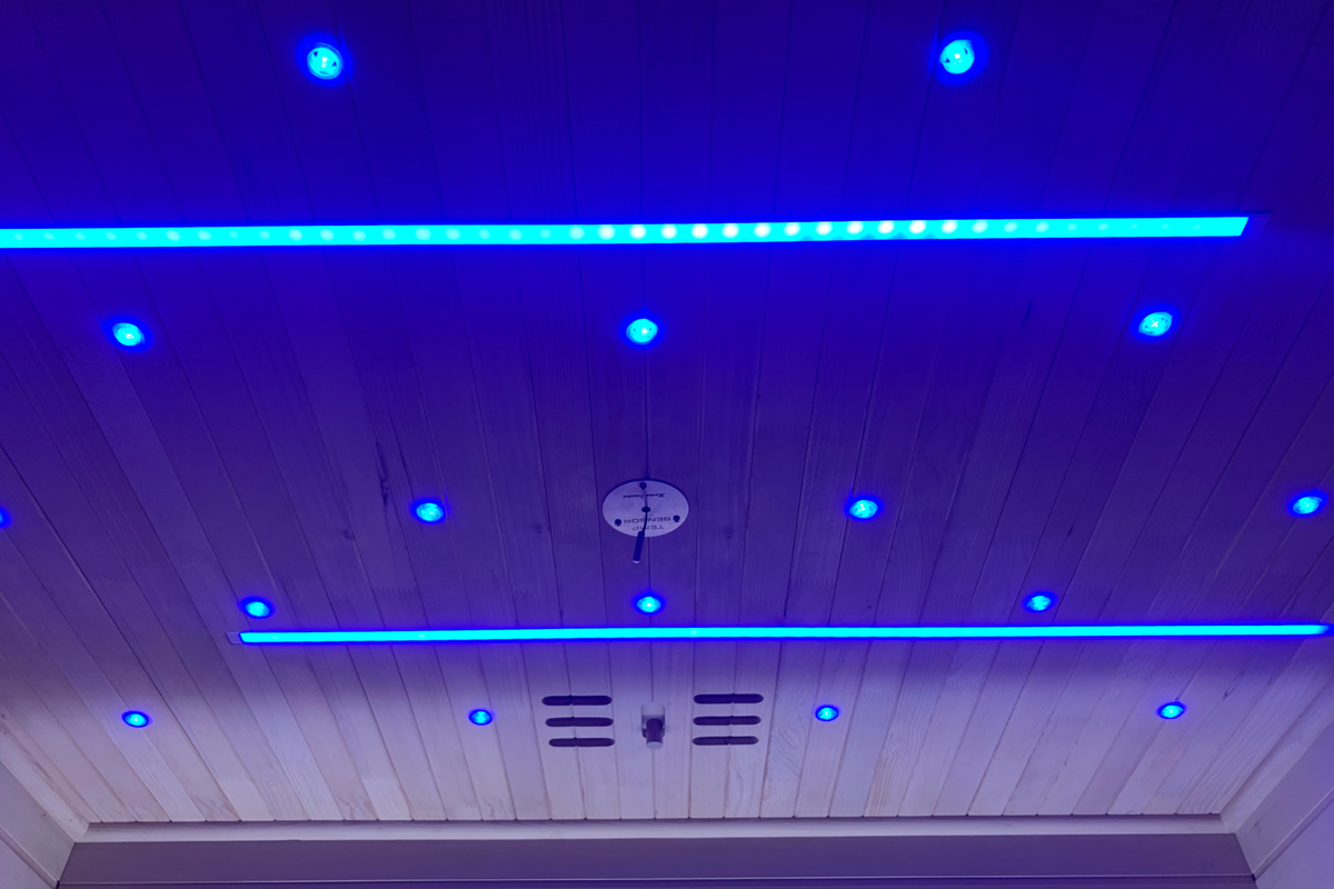 Blue LED accent lighting illuminating the ceiling inside the Blisspod Bergen Deluxe sauna
