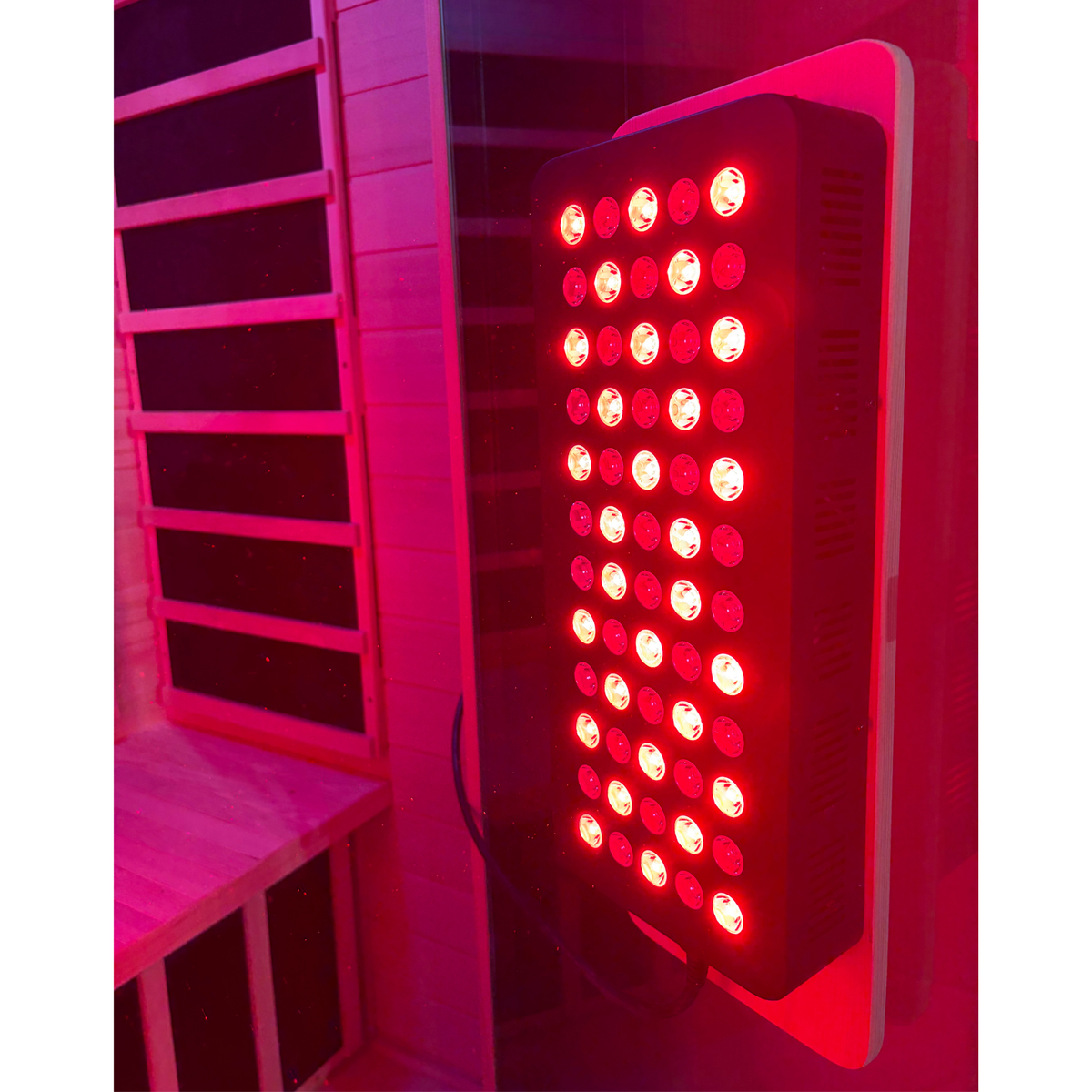 Illuminated red light therapy panel inside Blisspod Malmo sauna