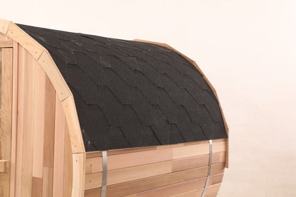 Dark shingles covering the curved roof of the Blisspod Prague cedar barrel sauna