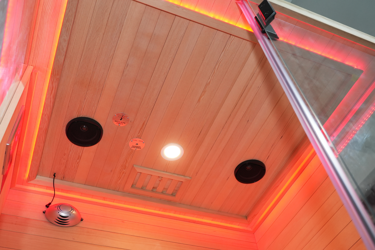 Warm LED ceiling lighting inside the Blisspod Vantaa RED infrared sauna
