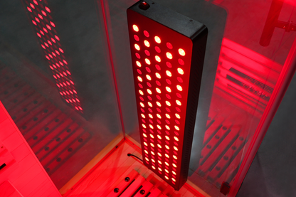 Illuminated red light therapy panel inside the Blisspod Vantaa RED sauna
