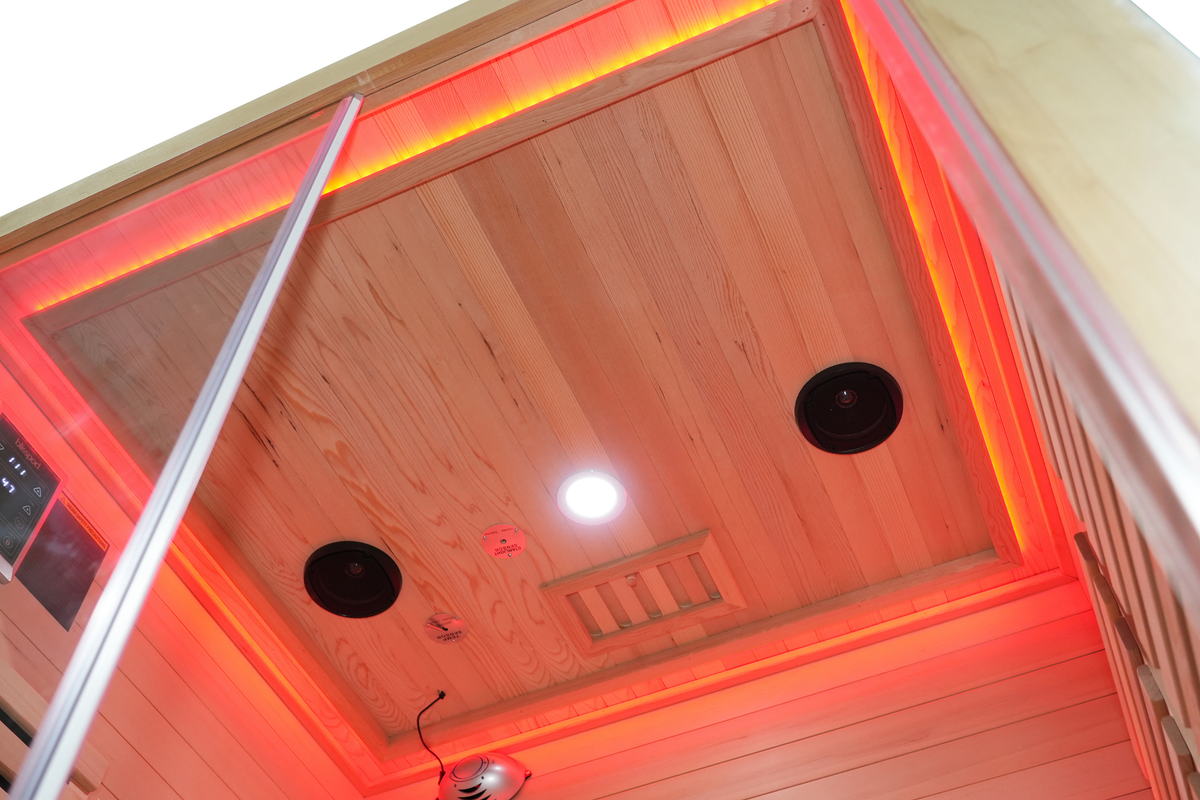 Warm ceiling lighting inside the Blisspod Venetian RED infrared sauna
