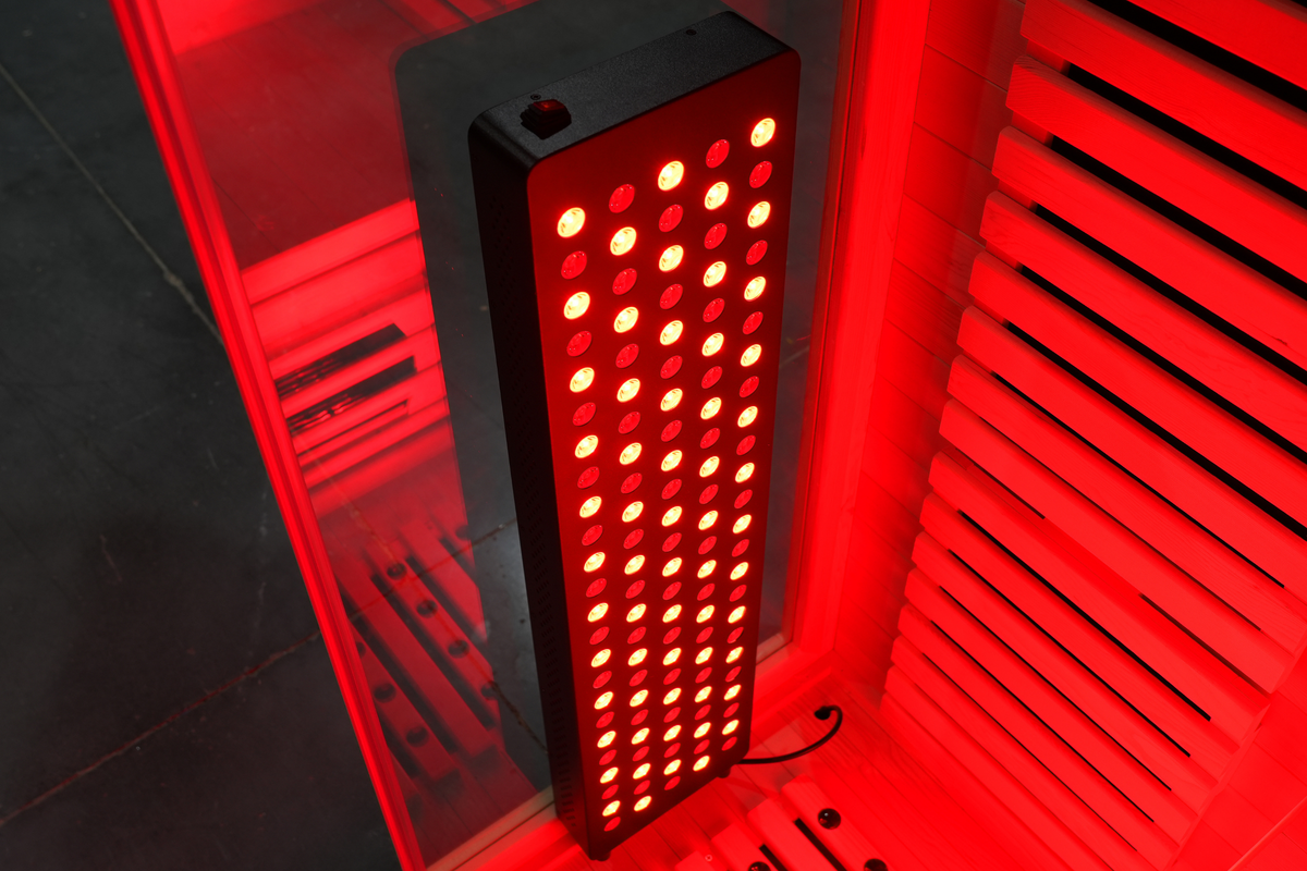 Illuminated red light therapy panel inside the Blisspod Venetian RED infrared sauna
