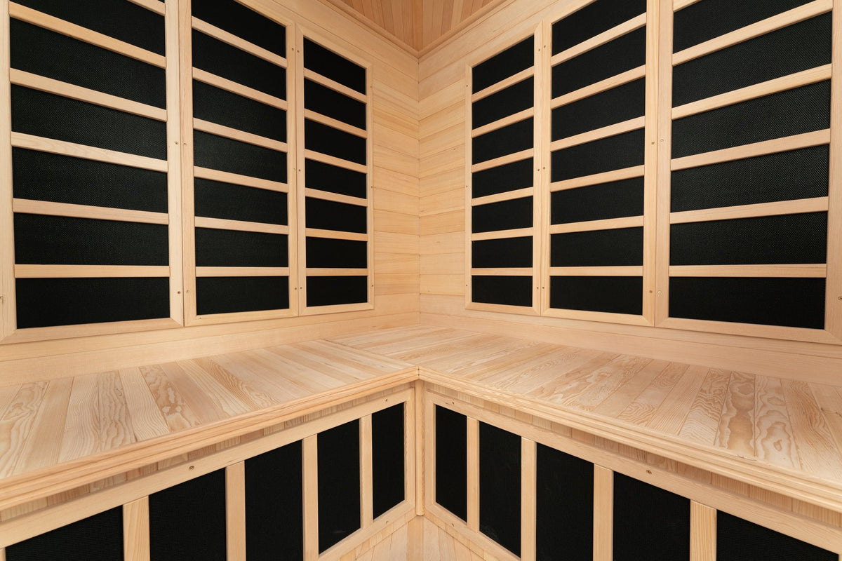 Corner bench seating and wall-mounted infrared heater panels inside the Blisspod Vienna sauna
