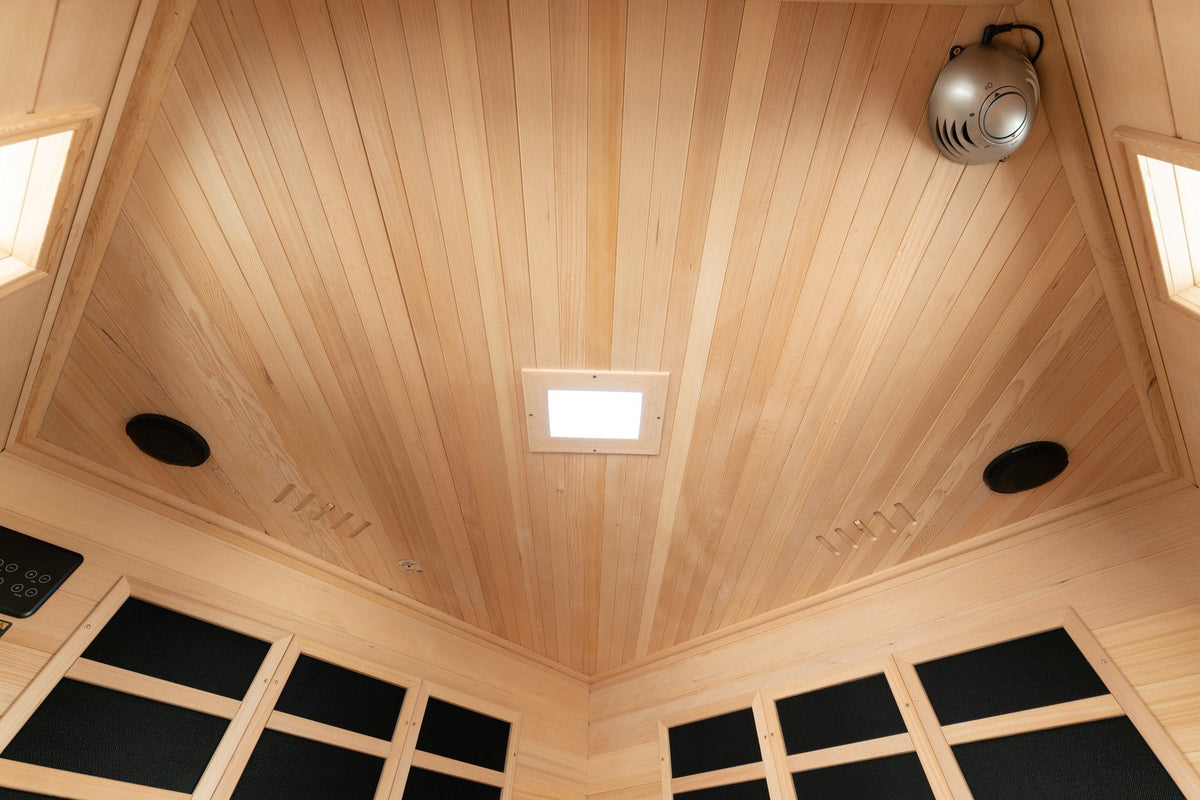 Wood ceiling inside the Blisspod Vienna infrared sauna showing lighting and circular fixtures