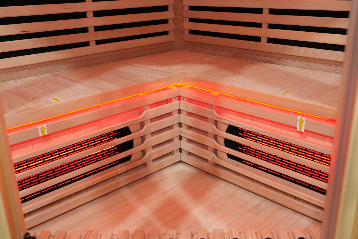 Corner seating bench and Canadian hemlock wood interior of the Blisspod Vienna RED sauna
