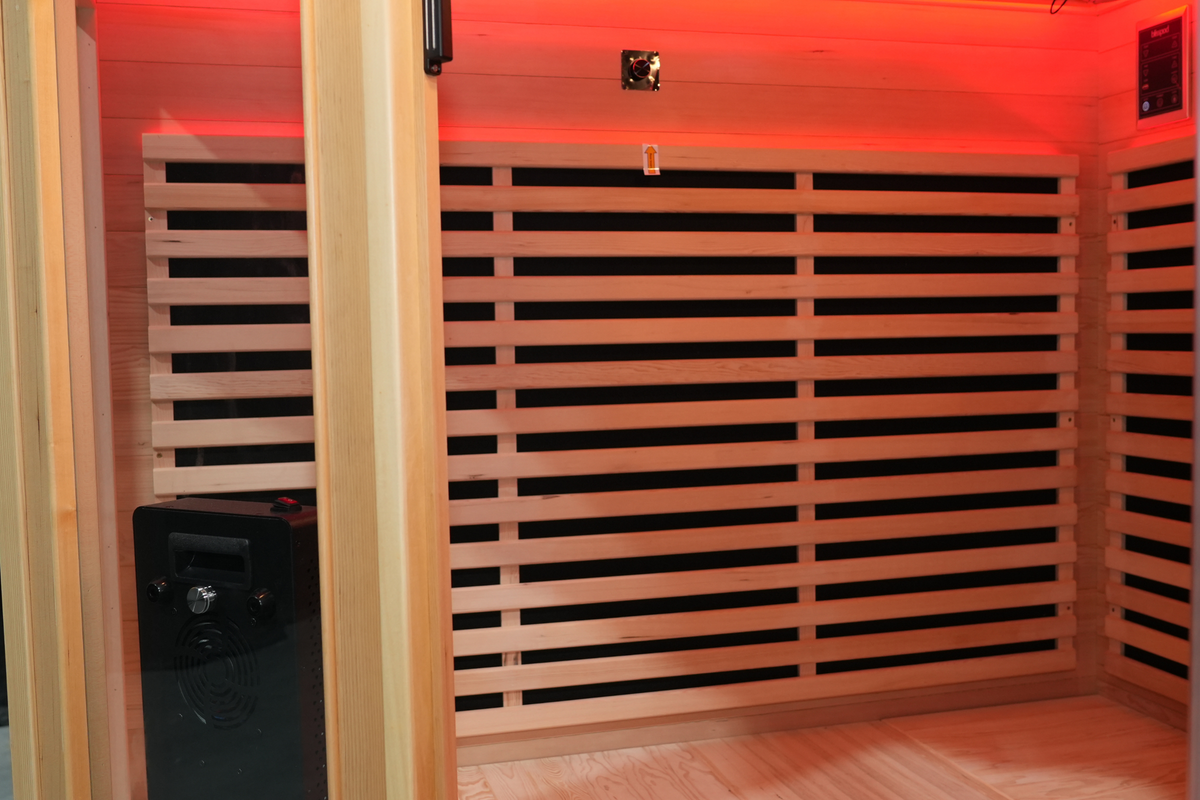 Interior wooden heater guards and upper wall inside the Blisspod Vienna RED infrared sauna
