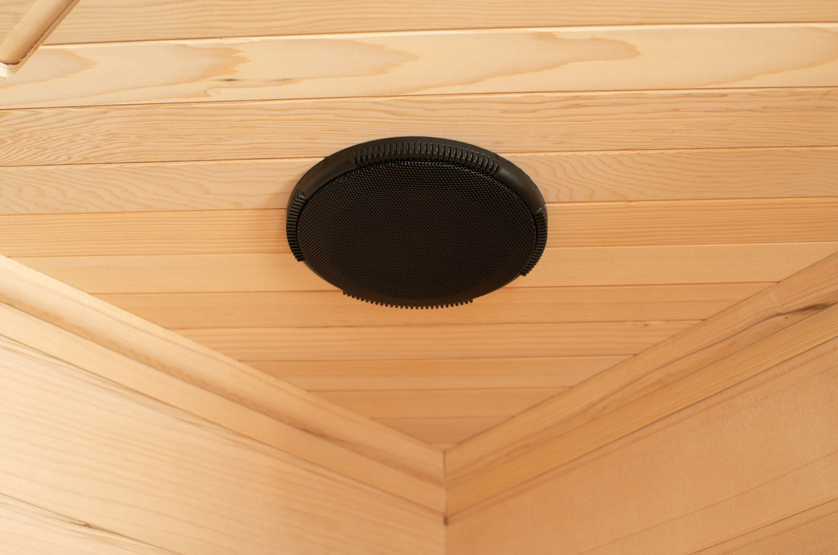 Built-in circular speaker set into the wood ceiling of the Blisspod Vienna sauna