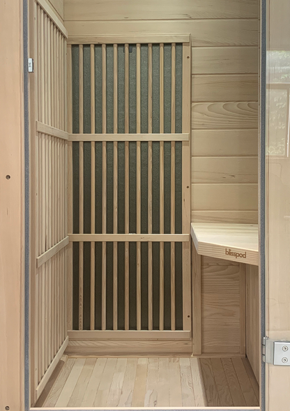 Interior of Blisspod Vienna sauna showing wooden bench and infrared heating panels
