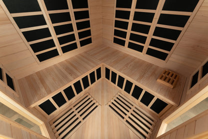 Interior view of the Blisspod Vienna corner sauna showing infrared heater panels, wooden benches and floor