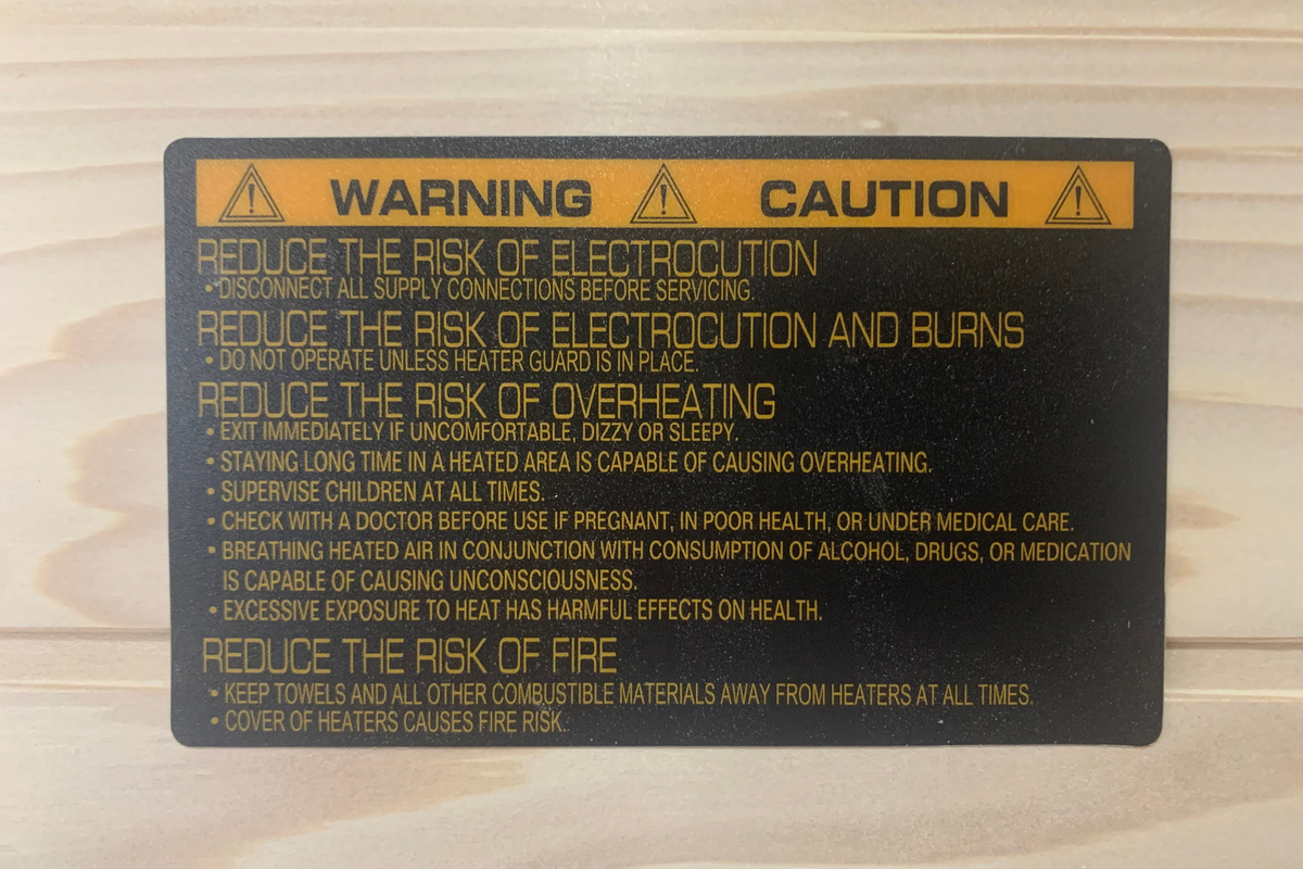 Manufacturer safety warning label inside Blisspod Vienna 1-person infrared sauna covering electrical, overheating and fire precautions