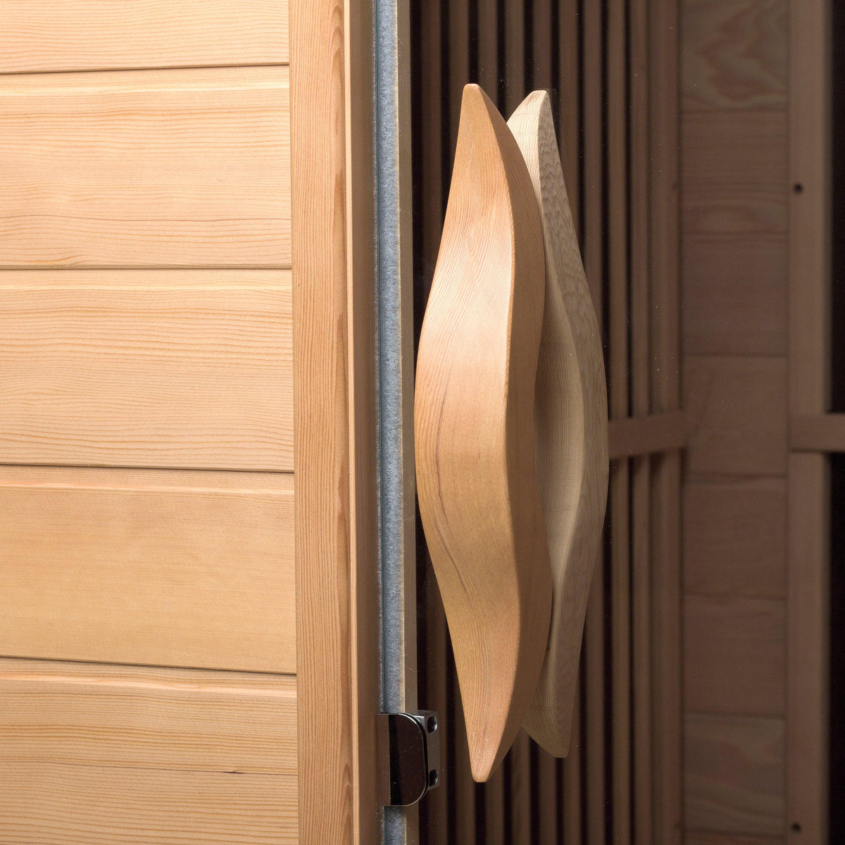 Close-up of curved wooden door handle on the Durasage 2-person infrared sauna