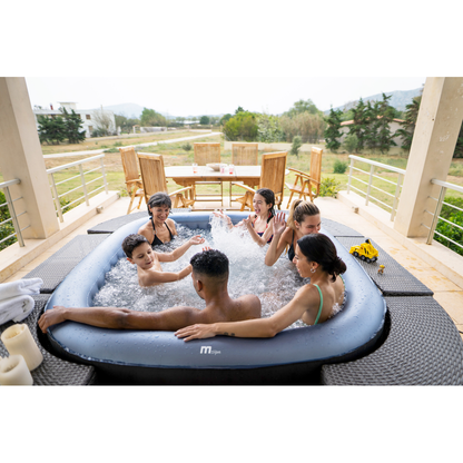 Group seated in an MSpa Tekapo inflatable hot tub on a wooden outdoor deck